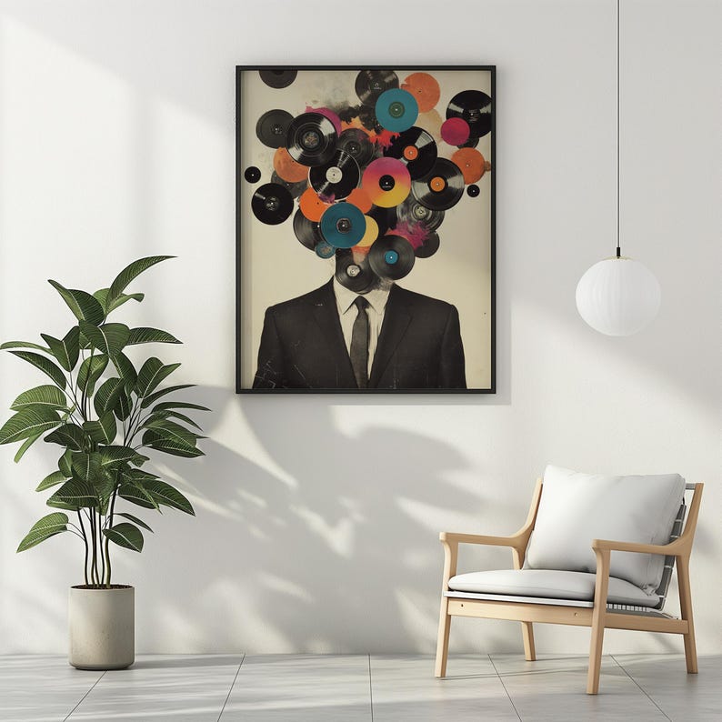 May include: Framed art print featuring a man in a suit with a head composed of colorful vinyl records. The artwork has a vintage aesthetic, with a neutral background and a black frame. The records are in various colors, including blue, orange, and pink.