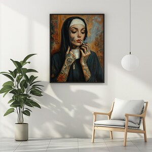 May include: Framed art print of a nun smoking a cigarette. The nun is wearing a black habit and a white wimple. Her arms are covered in tattoos. The background is a mix of orange, brown, and blue.