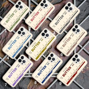 May include: Nine phone cases with a butter-themed design. Each case features the words "Salted Butter AA" and a ruler-style measurement guide. The cases have different colored borders, including green, red, blue, and brown.