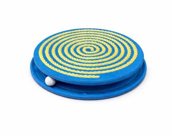 May include: A blue cat toy with a yellow spiral design on top. A small white ball sits in the groove of the toy. The toy is round and has a raised edge.