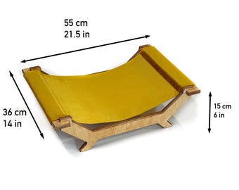 May include: A mustard yellow fabric pet hammock suspended on a light-colored wooden frame. The structure measures 21.5 inches in length, 14 inches in width, and 6 inches in height, as indicated by the dimension lines and text labels on the image.