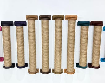 May include: A collection of cat scratching posts in various sizes and colors. Each post is wrapped in natural sisal rope and features a wooden base and top. Colors include yellow, pink, black, purple, brown, green, and blue.