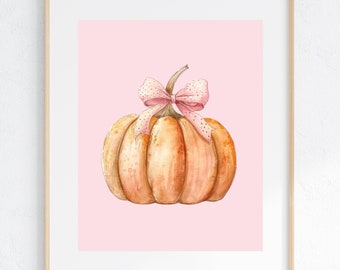 Puede incluir: Una pintura de acuarela de una calabaza con un lazo rosa de lunares sobre un fondo rosa.