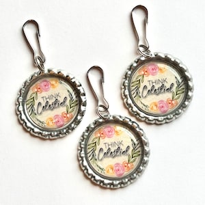 May include: Three silver zipper pulls with floral designs and the text "Think Celestial" on each. The flowers are pink, yellow, and green.