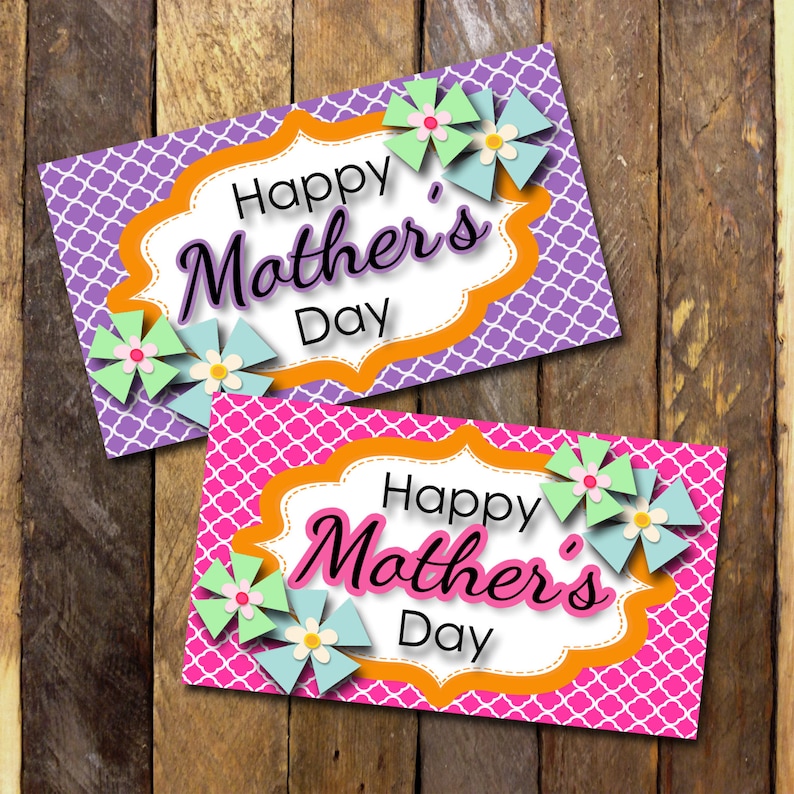 May include: Two printable gift tags with a purple and pink background featuring a white scalloped frame with the text "Happy Mother's Day" in black script. The tags are decorated with colorful paper flowers.