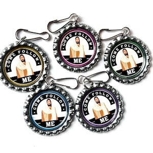 May include: Five bottle cap keychains with a religious theme. Each cap features an image of Jesus and the words "COME FOLLOW ME". The caps have different colored borders: yellow, pink, green, blue, and purple. Each keychain has a silver clasp.