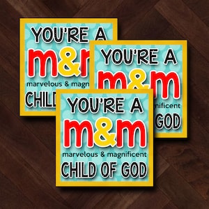 May include: Three yellow and blue cards with white polka dots. Each card says "You're a m&m" with the "m" in red and the "&" in yellow. The text below the "m&m" says "marvelous & magnificent CHILD OF GOD".