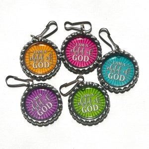 May include: Five bottle cap charms with silver-colored edges and attached clasps. Each charm features the text "I AM A child of GOD" in a white font, set against a colorful background of orange, pink, teal, purple, and green.