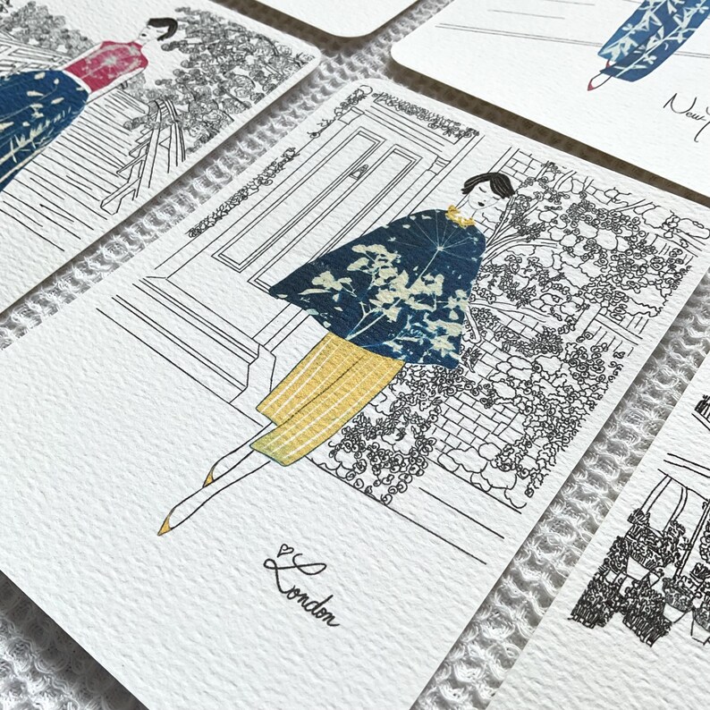 May include: A black and white illustration of a woman wearing a blue and white patterned cape and yellow pants. The woman is standing in front of a building with a door and a garden. The text "London" is written below the woman.