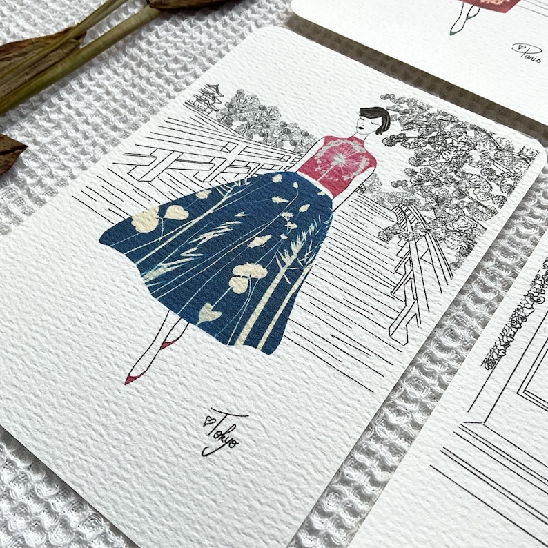 May include: A black and white illustration of a woman wearing a red and white patterned top and a blue and white patterned skirt. She is walking on a bridge with a Japanese garden in the background. The image is signed "Tokyo" in the bottom right corner.