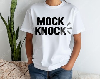 May include: White t-shirt with black text that reads "MOCK KNOCK" on the front.