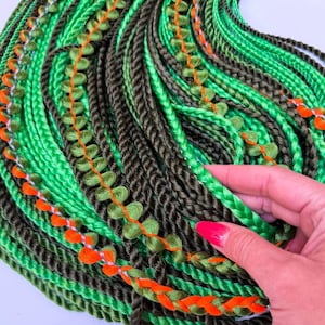 Long dreads.Synthetic mix braids extensions,twists.Double braids, twists mix of green, black&accent orange color.Long afro braids extensions