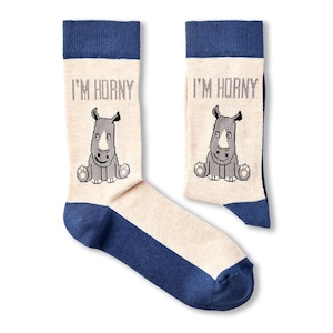 May include: A pair of beige and blue socks with a rhino graphic and the text "I'm Horny" on each sock.
