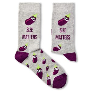 May include: A pair of grey socks with a purple aubergine design and the text "Size Matters".