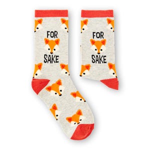 May include: A pair of grey socks with a red cuff and orange fox faces. The socks have the text "FOR SAKE" printed on them.