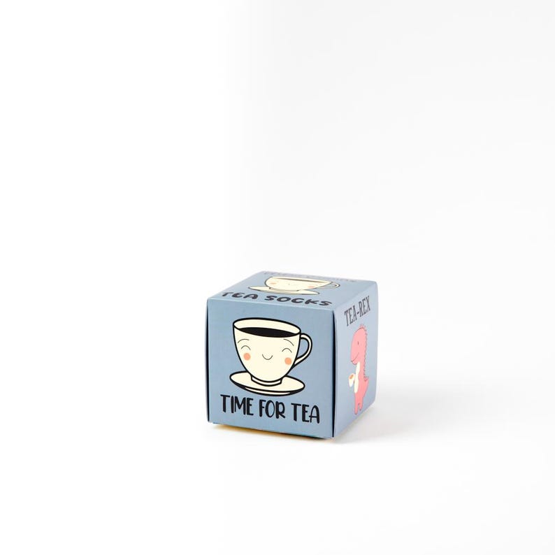 May include: A blue box with a cartoon teacup and the text "Time for Tea". The box also has the text "Tea-Rex" and "Tea Socks" on the sides.
