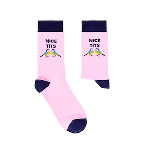 May include: A pair of pink socks with navy blue heels, toes, and cuffs. Each sock features the text "NICE TITS" above a graphic of two blue and yellow birds.