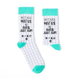 May include: A pair of white socks with a green cuff and a grid pattern. The socks have the text "NOT ALL MATHS IS AWFUL JUST SUM" and the symbols "+-×÷=" printed on them.