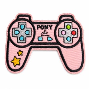 Può includere: Una toppa ricamata rosa a forma di controller per videogiochi con contorni neri. Presenta la parola PONY, due stelle gialle e un pad direzionale con accenti azzurri. Il lato destro ha quattro pulsanti circolari in verde, rosa, rosso e blu.