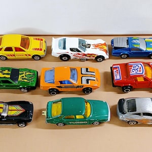 Vintage 9 Diecast Sports Cars, 5 Hot Wheels, and 4 Majorette, all in various conditions, see description