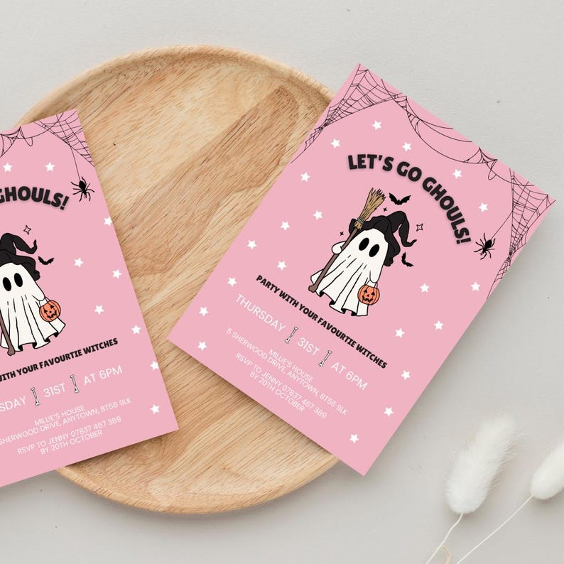 May include: Pink Halloween party invitations with a cartoon ghost holding a pumpkin and broom. The text reads "Let's Go Ghouls!" and "Party with your favourite witches". The invitations are decorated with spiderwebs and stars.
