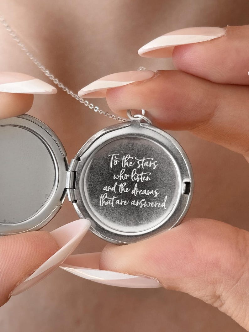 May include: Silver locket necklace with a quote engraved on the front: "To the stars who listen and the dreams that are answered".