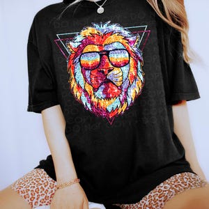 May include: A black t-shirt with a rainbow glitter lion wearing sunglasses in a triangle design. The text "Do Not Copy" is repeated around the design.