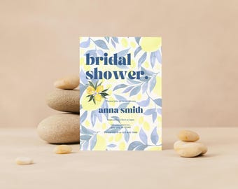 May include: A yellow and blue bridal shower invitation with a lemon and leaf pattern. The text reads "bridal shower" in blue and "anna smith" in blue. The invitation also includes the date and time of the shower.