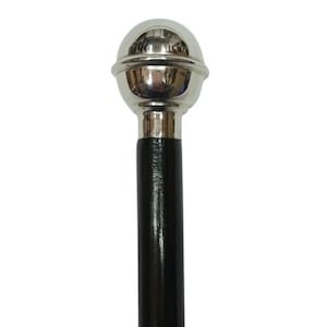 May include: A black wooden walking stick with a silver ball-shaped handle.
