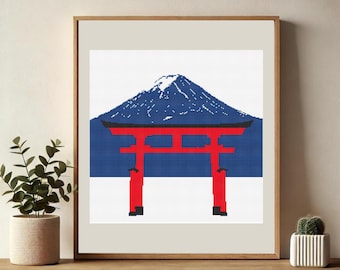 Op de afbeelding: Ingelijste kunst met een gepixeleerde illustratie van een rode Torii-poort voor een blauwe berg en een witte achtergrond. De berg heeft een besneeuwde top. Het kunstwerk zit in een houten lijst.