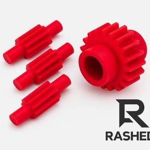 May include: Four red plastic gears, one large and three smaller, are arranged on a white surface. The large gear has a central hole and external teeth. The smaller gears have a cylindrical shape with teeth. The word "RASHED" is below a stylized "R" logo.