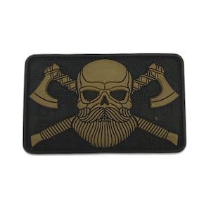 May include: A rectangular patch featuring a gold skull with a long beard and crossed axes on a black background. The axes are positioned behind the skull, and the design has a textured appearance.