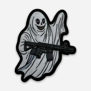May include: A white ghost patch with a black outline, holding a black rifle. The ghost has a smiling face and is wearing a white sheet. The patch is a unique design, perfect for adding to clothing or accessories.
