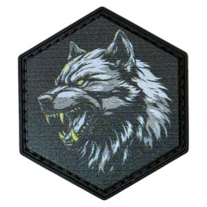 May include: A black and gray hexagonal patch featuring a detailed illustration of a snarling wolf. The wolf's fur is rendered in shades of gray and white, with yellow eyes and teeth. The patch has a black border.