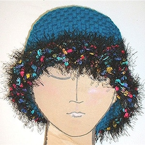 May include: A teal blue crocheted hat with a black fuzzy trim and colourful accents. The hat is worn by a doll with a painted face.