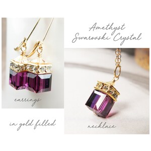 May include: Amethyst Swarovski crystal earrings and necklace in gold filled. The earrings and necklace feature a square-shaped crystal with a gold-toned frame and clear crystal accents.