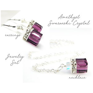 May include: Amethyst Swarovski crystal jewelry set, featuring a necklace and earrings. The necklace is a silver chain with a pendant featuring a purple crystal with clear crystal accents. The earrings are silver hooks with a purple crystal and clear crystal accents.