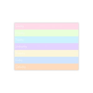 May include: A pastel rainbow planner with the days of the week listed: Sunday, Monday, Tuesday, Wednesday, Thursday, Friday, Saturday.
