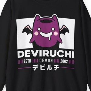 May include: Black sweatshirt featuring a purple cartoon demon character with bat wings, a smiling face, and a white drool. The design includes the text "DEVIRUCHI" above "ESTD DEMON 2002" and Japanese characters.