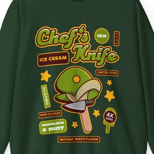 Puede incluir: Sudadera verde oscuro con un gráfico de un helado con forma de cuchillo de chef. El texto incluye "Chef's Knife Ice Cream", "9999 Calories" y "Chocolate & Mint". Texto adicional incluye "New" y "Limited Offer".