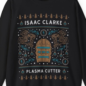 Peut inclure: Pull-over de Noël noir avec un motif brun et bleu représentant le texte "Isaac Clarke" et "Plasma Cutter".