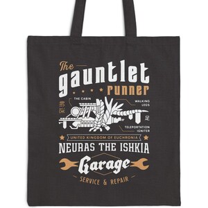 May include: Black tote bag with a white graphic design featuring a stylized illustration of a robot with the text "The Gauntlet Runner", "The Cabin", "Walking Legs", "Teleportation Igniter", "United Kingdom of Euchronia", "Neuras the Ishkia", and "Garage Service & Repair".