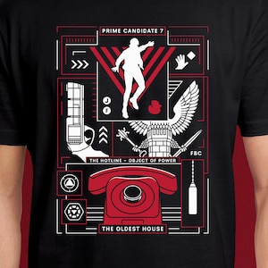 May include: A black t-shirt featuring a graphic print in white and red. The design includes a silhouette of a person, a rotary phone, a gun, an eagle emblem, and text reading PRIME CANDIDATE 7, THE HOTLINE - OBJECT OF POWER, and THE OLDEST HOUSE.