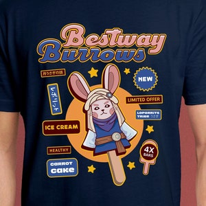 Puede incluir: Una camiseta azul con un conejo de dibujos animados en un palo de helado. El conejo lleva un atuendo azul y marrón y un turbante blanco. El texto de la camiseta dice "Bestway Burrows" e incluye frases como "Ice Cream", "Carrot Cake", "Healthy" y "4x Bars".
