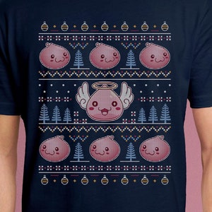 May include: A navy blue t-shirt with a pixelated Christmas sweater design featuring pink cartoon characters with angel wings and halos. The design includes Christmas trees and ornaments.