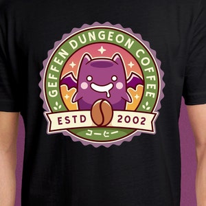 May include: Black t-shirt with a green, pink, and yellow circular logo. The logo features a purple cartoon bat with wings, a coffee bean, and the text "Geffen Dungeon Coffee EstD 2002".
