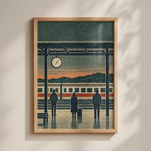 May include: A framed art print depicting a train station platform at dusk. Three figures stand on the platform waiting for a train with red and white stripes. A round clock hangs from the station roof, and distant mountains are visible in the background.