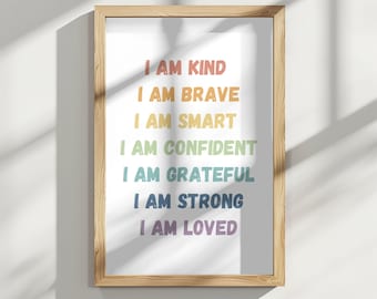 Puede incluir: Una impresión enmarcada con el texto "I AM KIND", "I AM BRAVE", "I AM SMART", "I AM CONFIDENT", "I AM GRATEFUL", "I AM STRONG" y "I AM LOVED" en colores arcoíris.