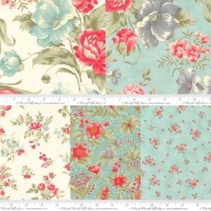 May include: A collection of fabric swatches featuring floral patterns in shades of cream, teal, and red. The designs include large blossoms, small rosebuds, and intricate botanical motifs. A white measuring tape is visible across the center.