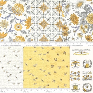 May include: A collection of cotton fabric swatches featuring yellow, gray, and white patterns of honeybees, floral arrangements, honeycomb, and cursive text. A white measuring tape is visible at the bottom, showing a length of 8 inches.